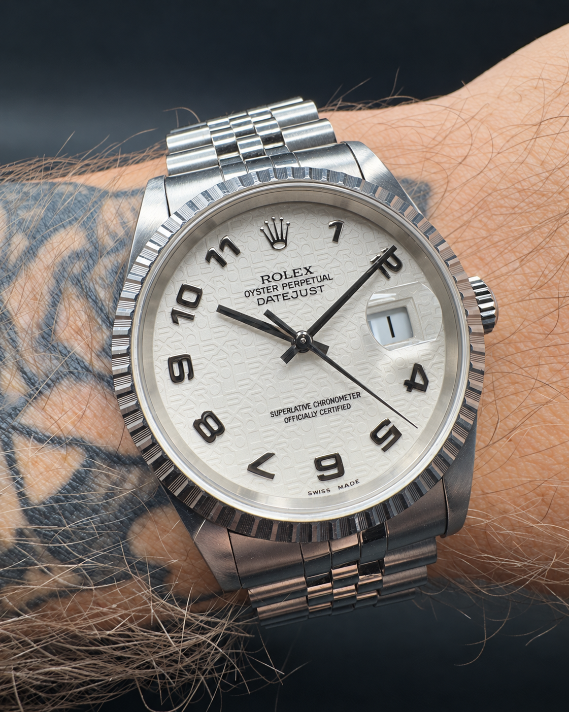 Rolex Datejust 16220 worn on the wrist, showing the white computer dial and stainless steel Jubilee bracelet.