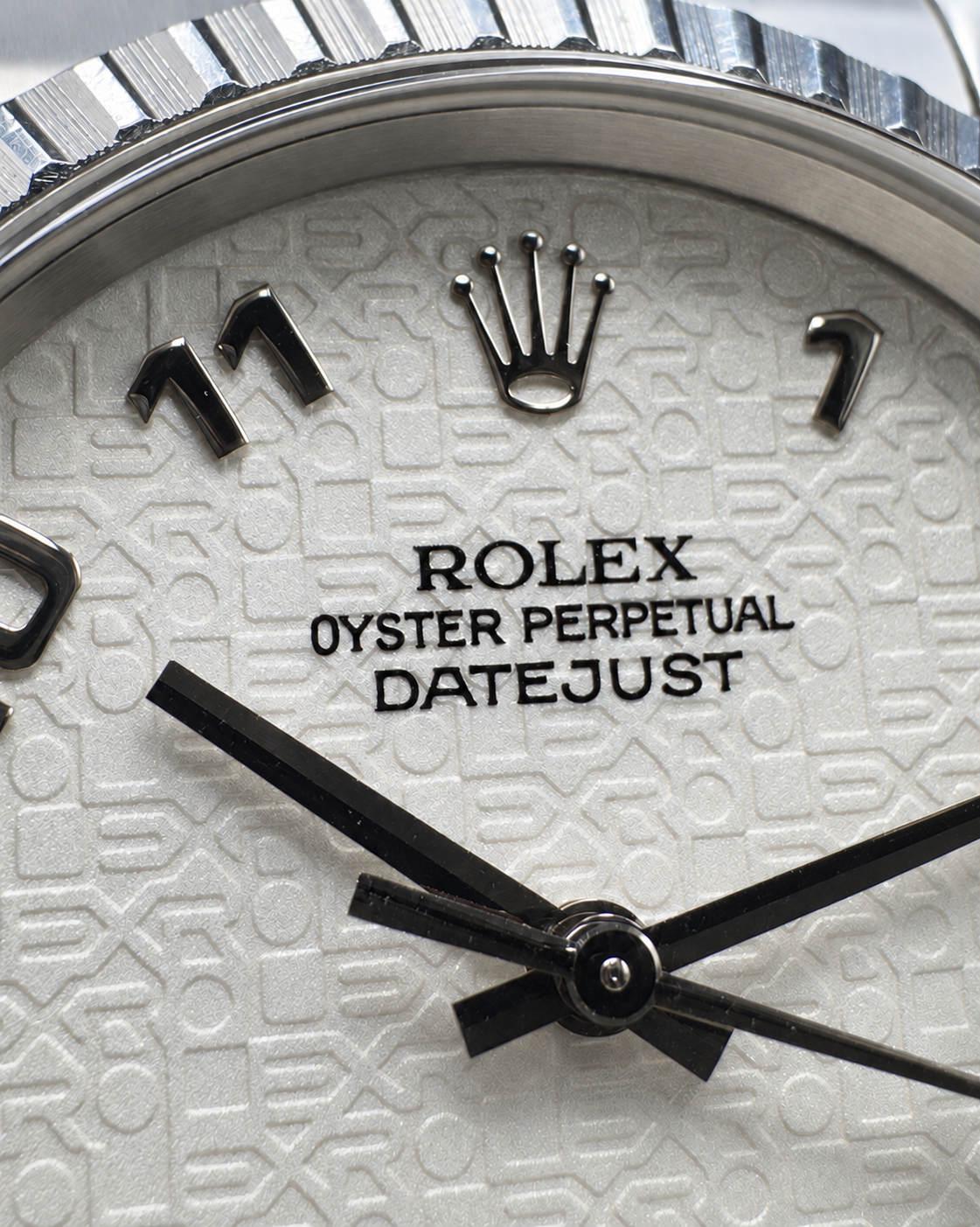 Macro view of the Rolex crown, dial lettering and embossed pattern on the Datejust 16220.