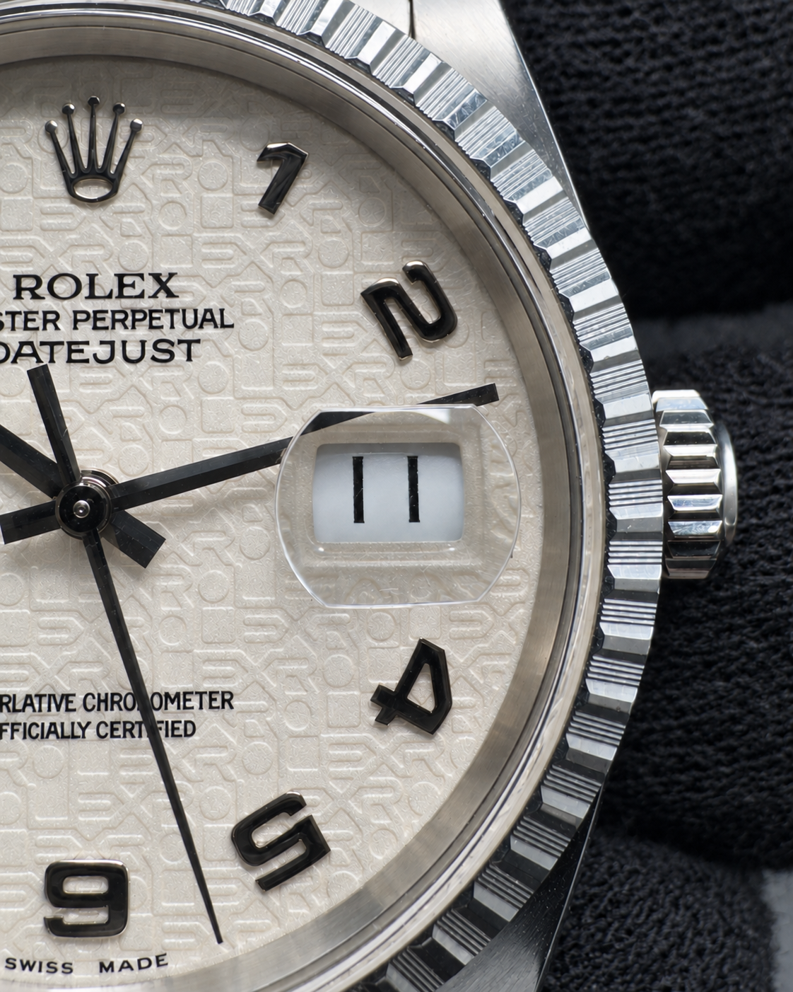 Close-up of the Datejust 16220 date window and Cyclops magnifier, with crown and engine-turned bezel.