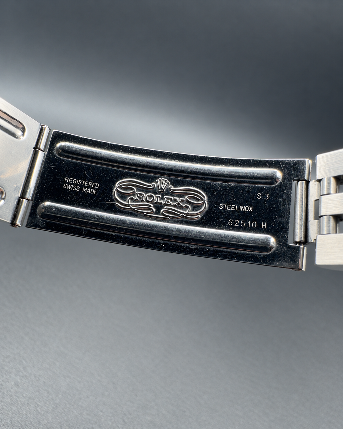 Inside the open Jubilee bracelet clasp, showing Rolex markings on the Datejust 16220.