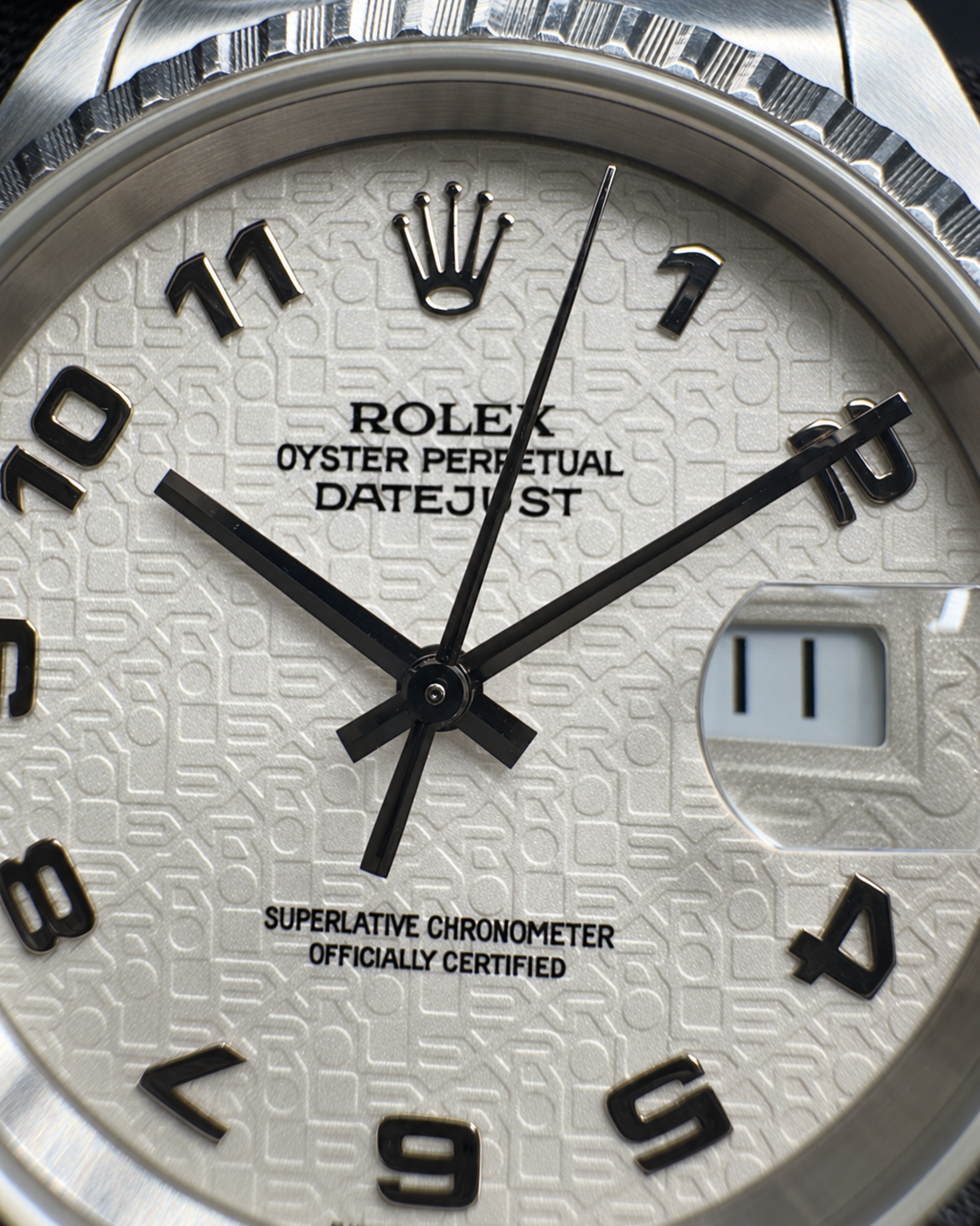 Detailed front view of the Rolex Datejust 16220 white computer dial, Arabic numerals and date magnifier.
