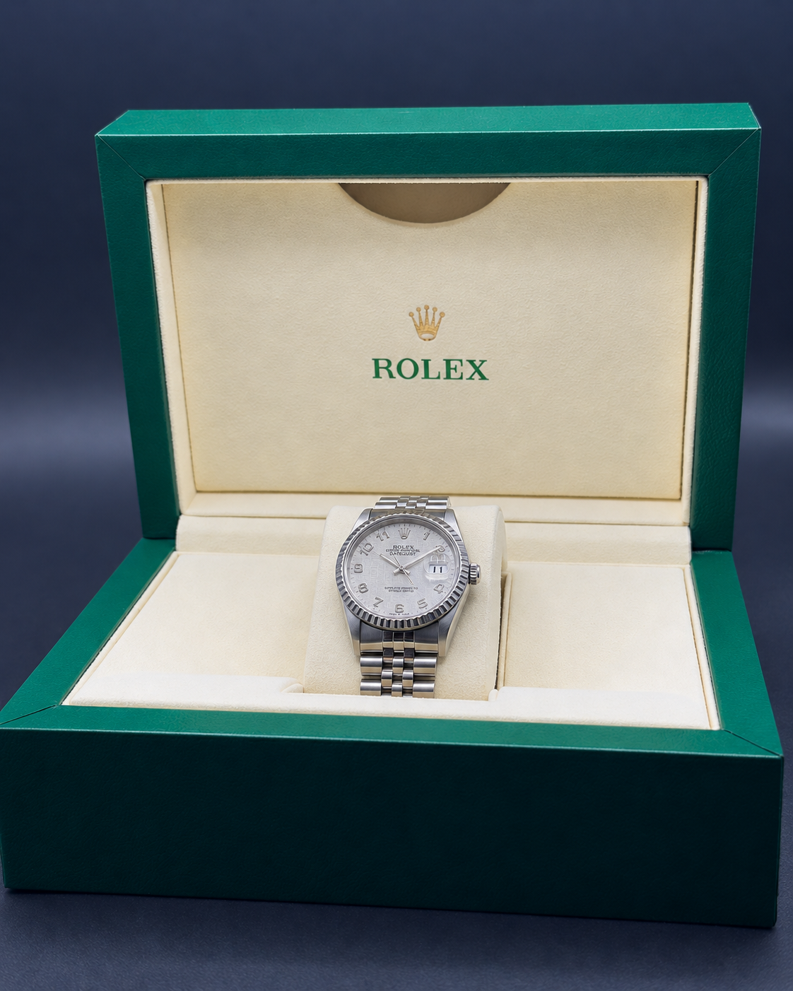 Rolex Datejust 16220 with white Jubilee computer dial displayed in an open green Rolex box.